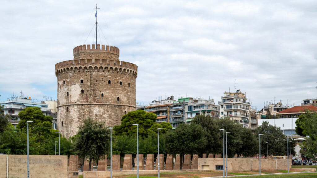 Architectural details of Thessaloniki, Greece, featuring historic buildings, the White Tower, and ancient ruins set against a clear sky