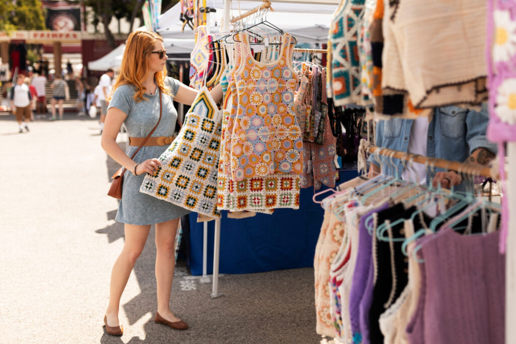 Bustling market scene in Chiang Mai with colorful stalls selling local crafts, souvenirs, and street food