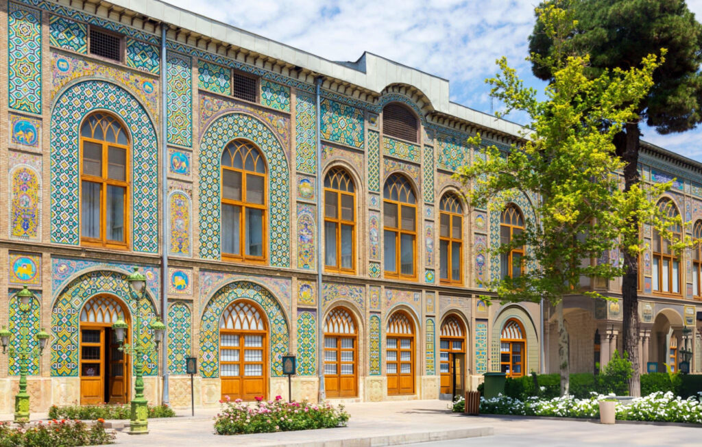 A historic view of Golestan Palace in Tehran, featuring intricate tilework and Persian architectural elements
