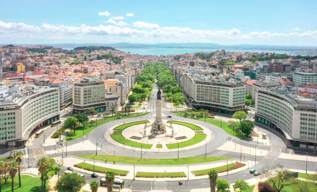 An overall view of Lisbon, showcasing the city's colorful buildings, historic landmarks, and the scenic Tagus River