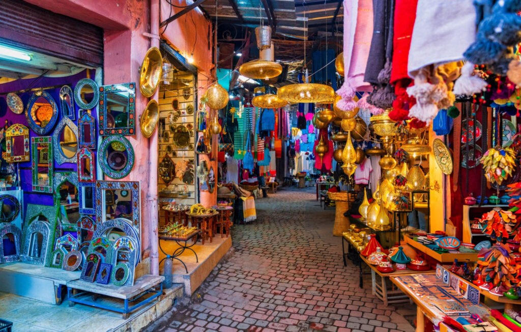 A bustling souk in Marrakesh, Morocco, with vibrant stalls selling traditional Moroccan goods