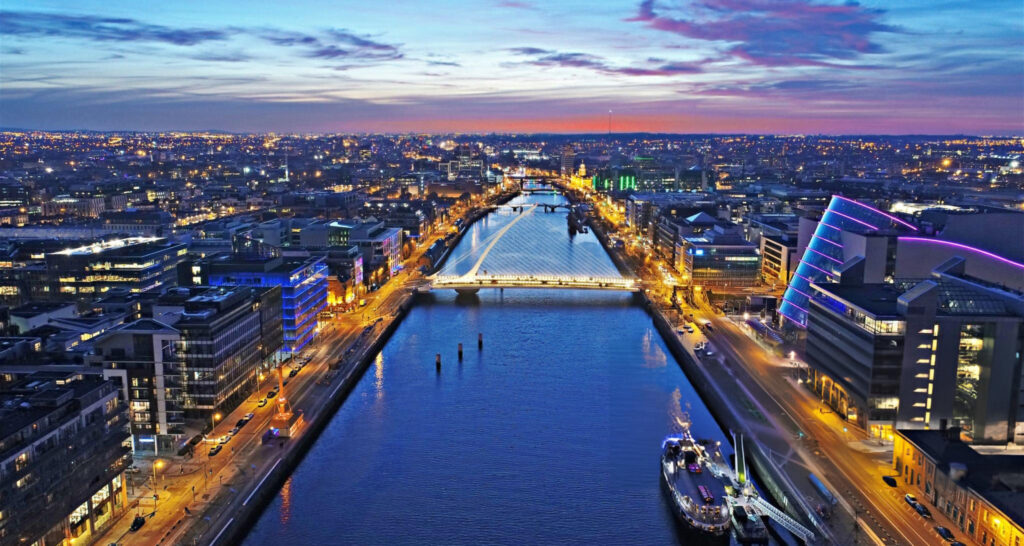 A vibrant nightlife scene in Dublin, showcasing lively streets filled with people, bars, and illuminated signs