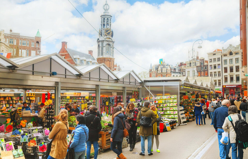 Shopping scene in Amsterdam featuring a bustling street with shops and boutiques