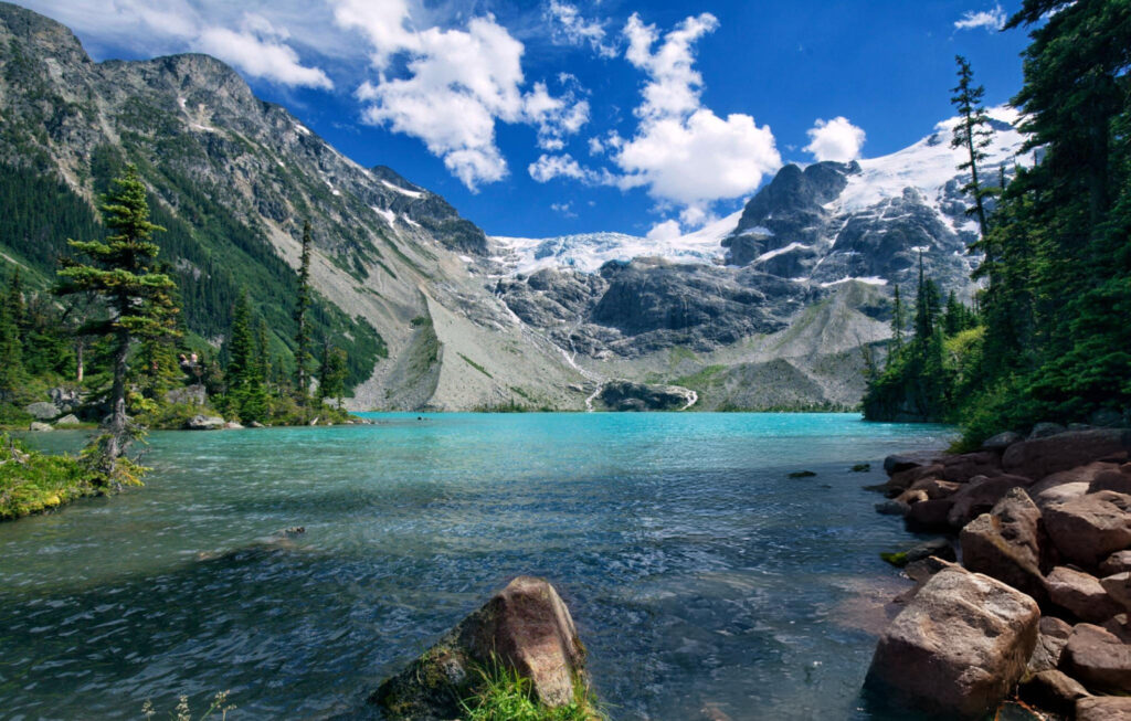 Mountain range near Vancouver, Canada, with snow-capped peaks and dense green forests covering the lower slopes