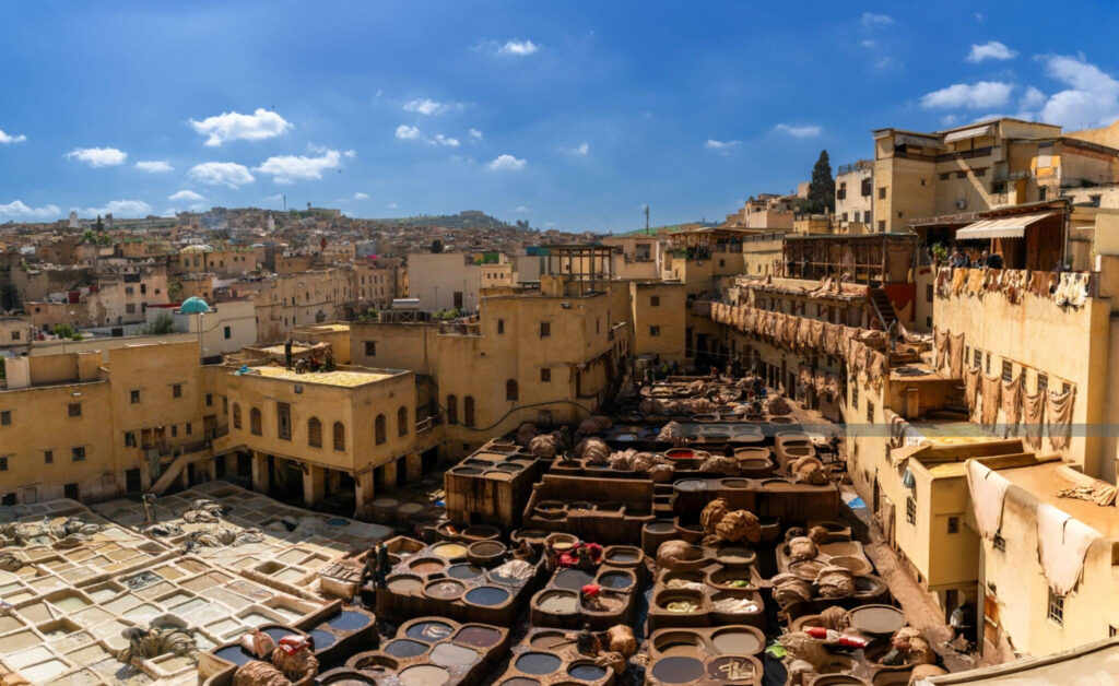 A general view of the Chouara Tannery in the Fes el-Bali quarter of downtown Fez, showing large open vats filled with colorful dyes and workers processing leather