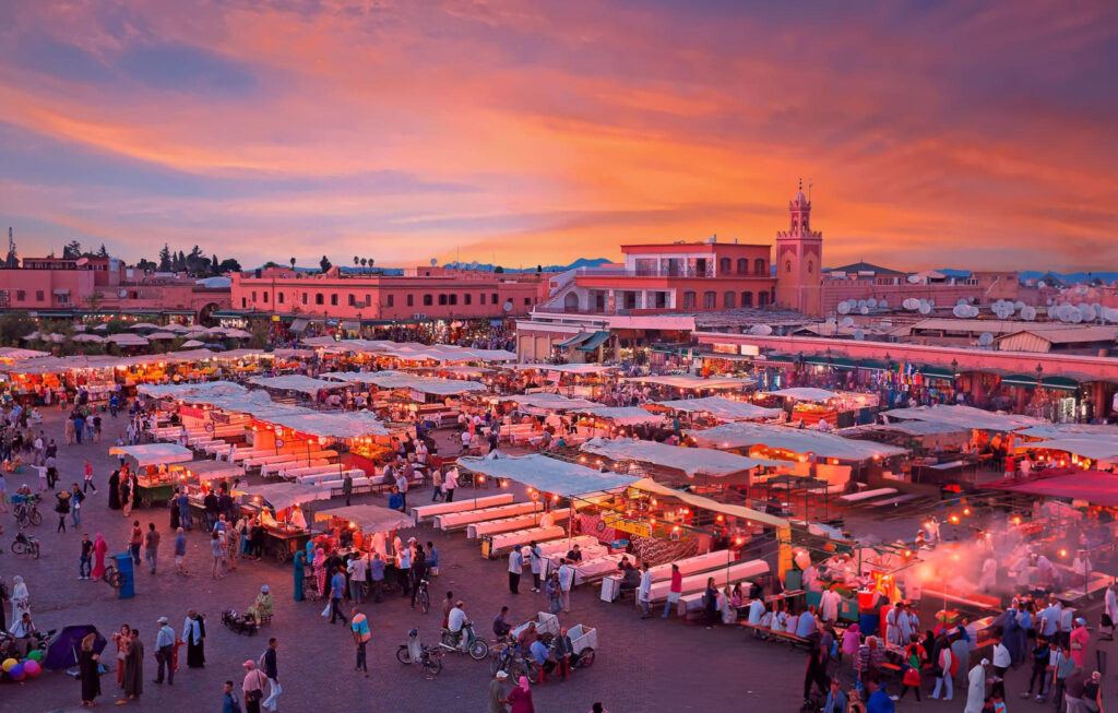 A vibrant cityscape of Marrakesh, Morocco, showcasing traditional Moroccan architecture and bustling streets