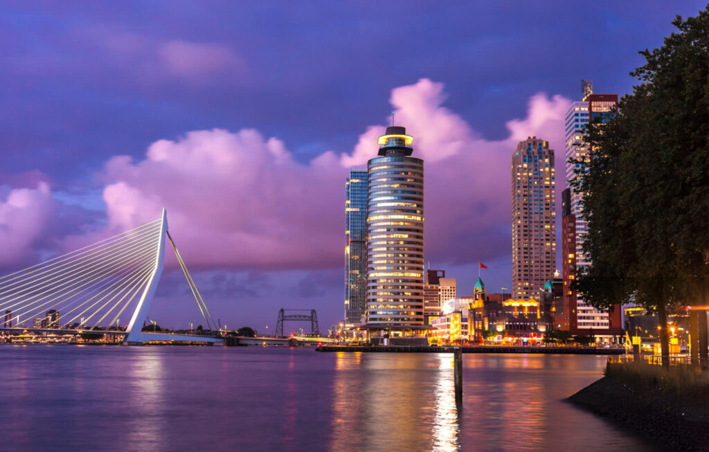 Vibrant nightlife scene in Rotterdam City, Netherlands with illuminated streets and bustling activity
