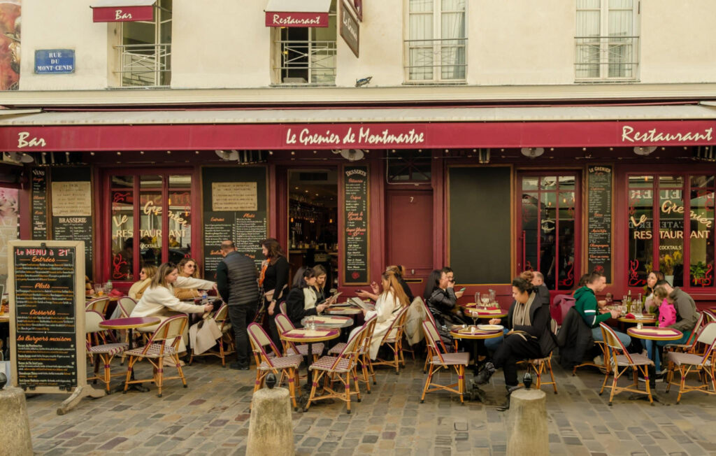 Parisian Cafe A bustling dining area in Paris with patrons enjoying their meals