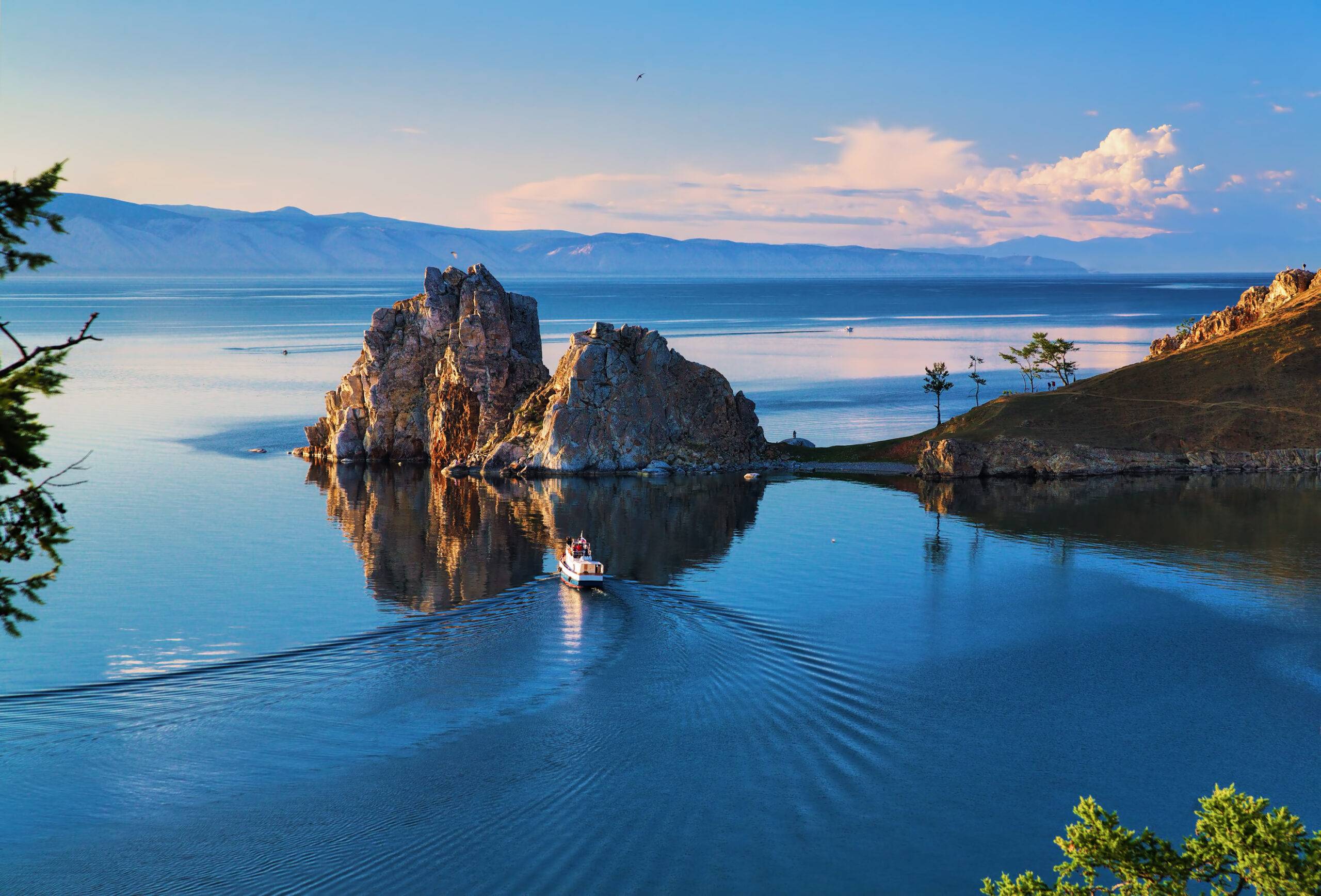 A breathtaking view of Lake Baikal, showcasing its crystal-clear waters and surrounding mountains in Siberia, Russia