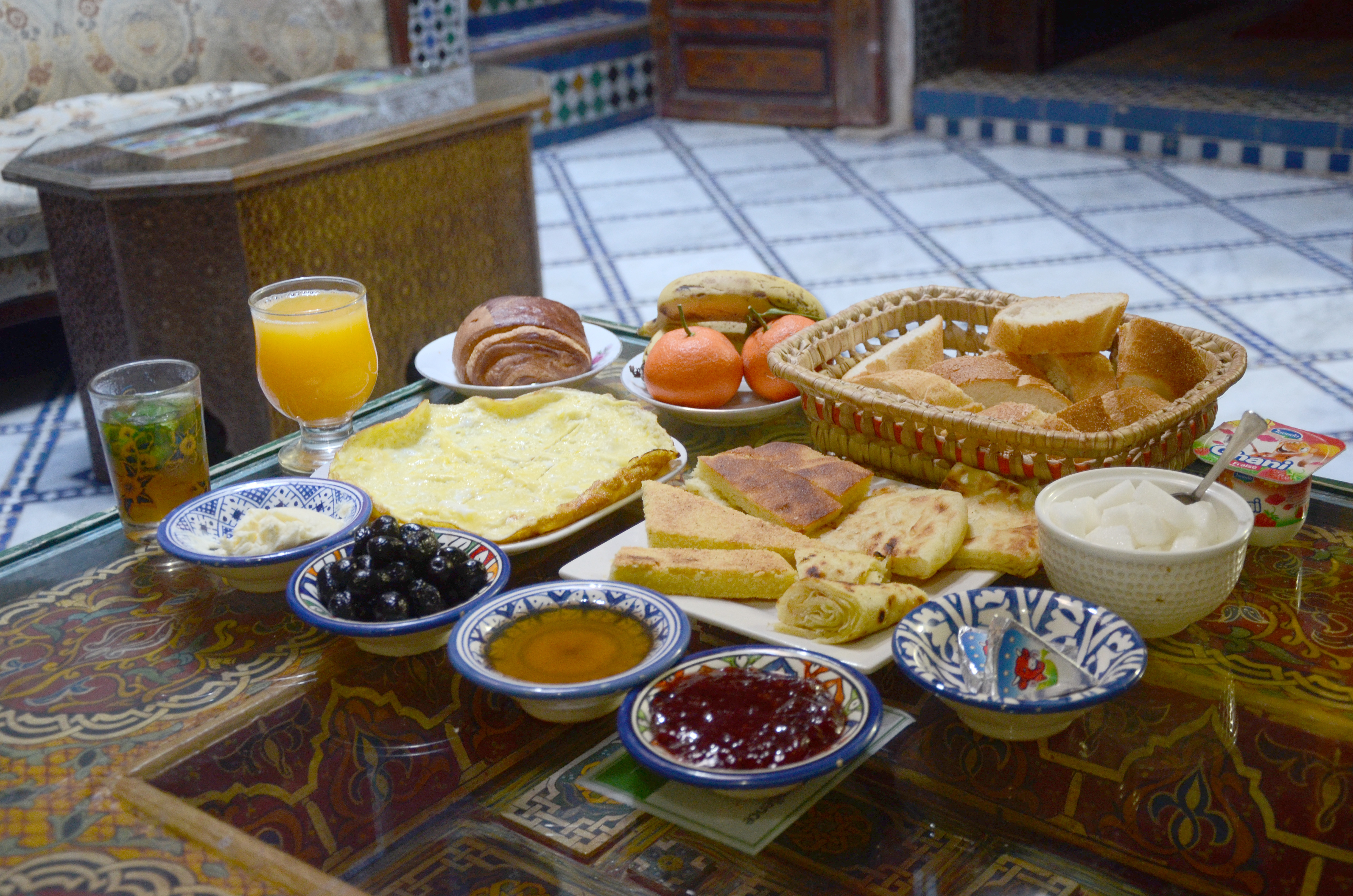 A colorful spread of traditional Persian dishes including chelo kebab, fesenjan, ghormeh sabzi, tahchin, dizi, and saffron ice cream