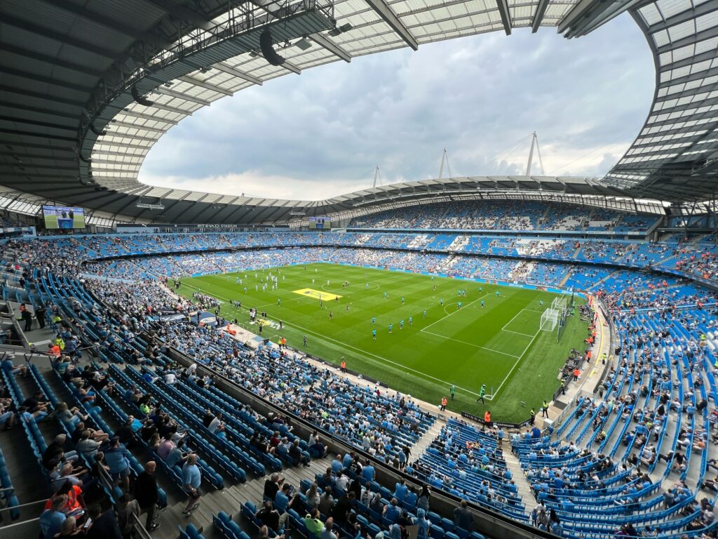 Manchester football stadium with empty seats and pitch