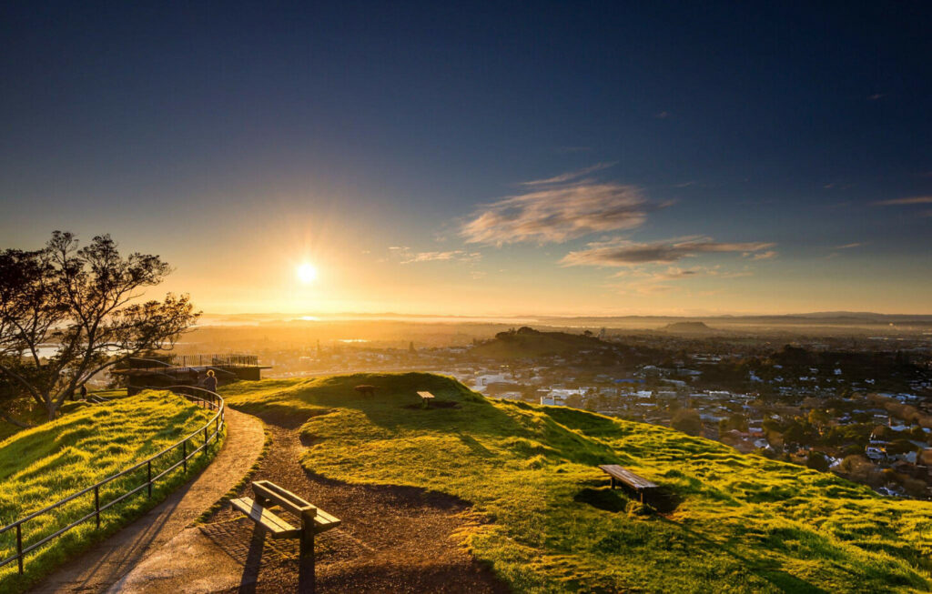 Scenic nature view in Auckland City with lush greenery and a serene lake