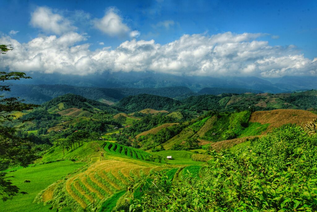 Scenic view of lush green mountains and a serene waterfall in Chiang Mai’s natural landscape
