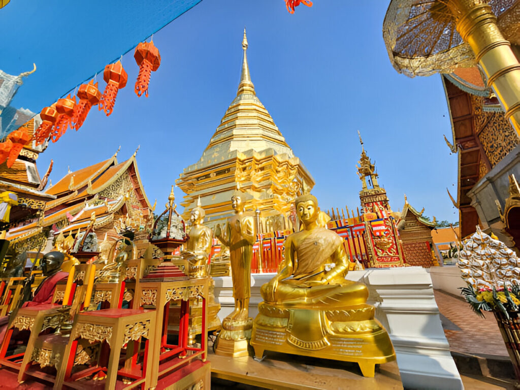 Traditional Thai temple in Chiang Mai with ornate roof decorations and detailed mural paintings