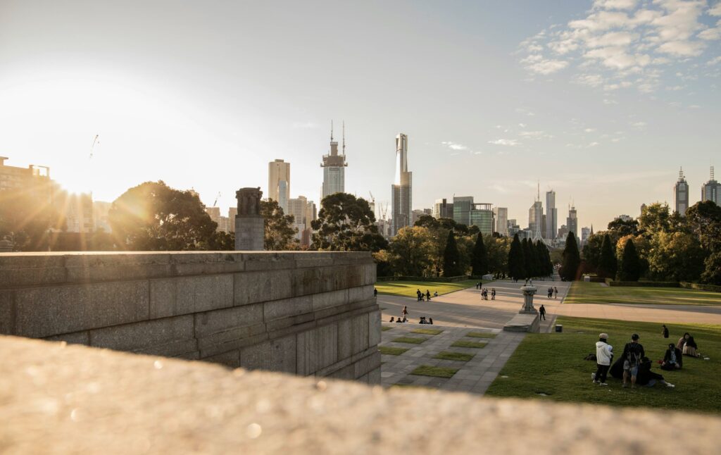 Aerial view of Melbourne City, Australia, with the skyline and sun setting in the background