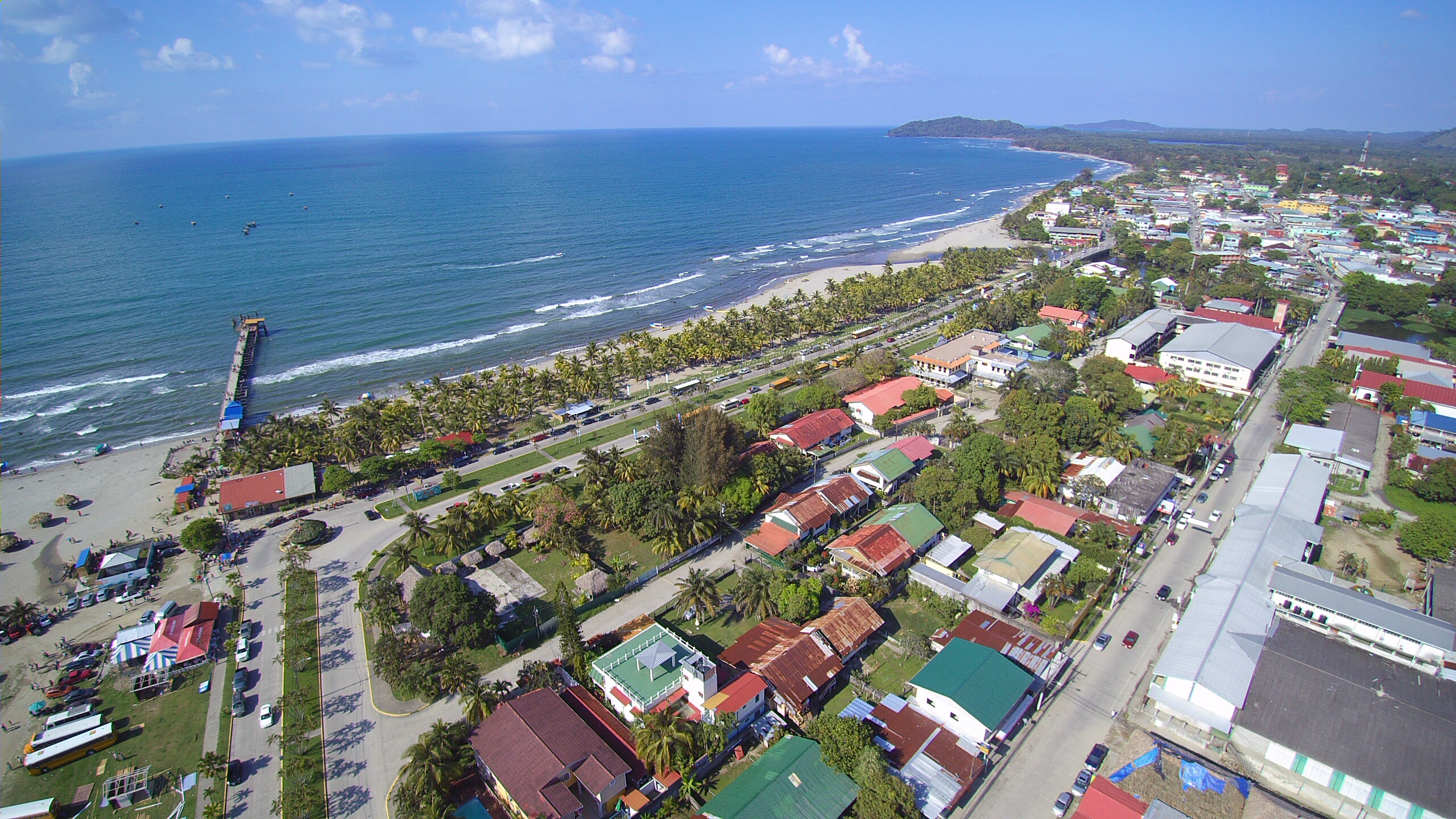 Aerial view of Tela, a coastal town in Honduras with its beautiful beaches, lush greenery, and the Caribbean Sea.