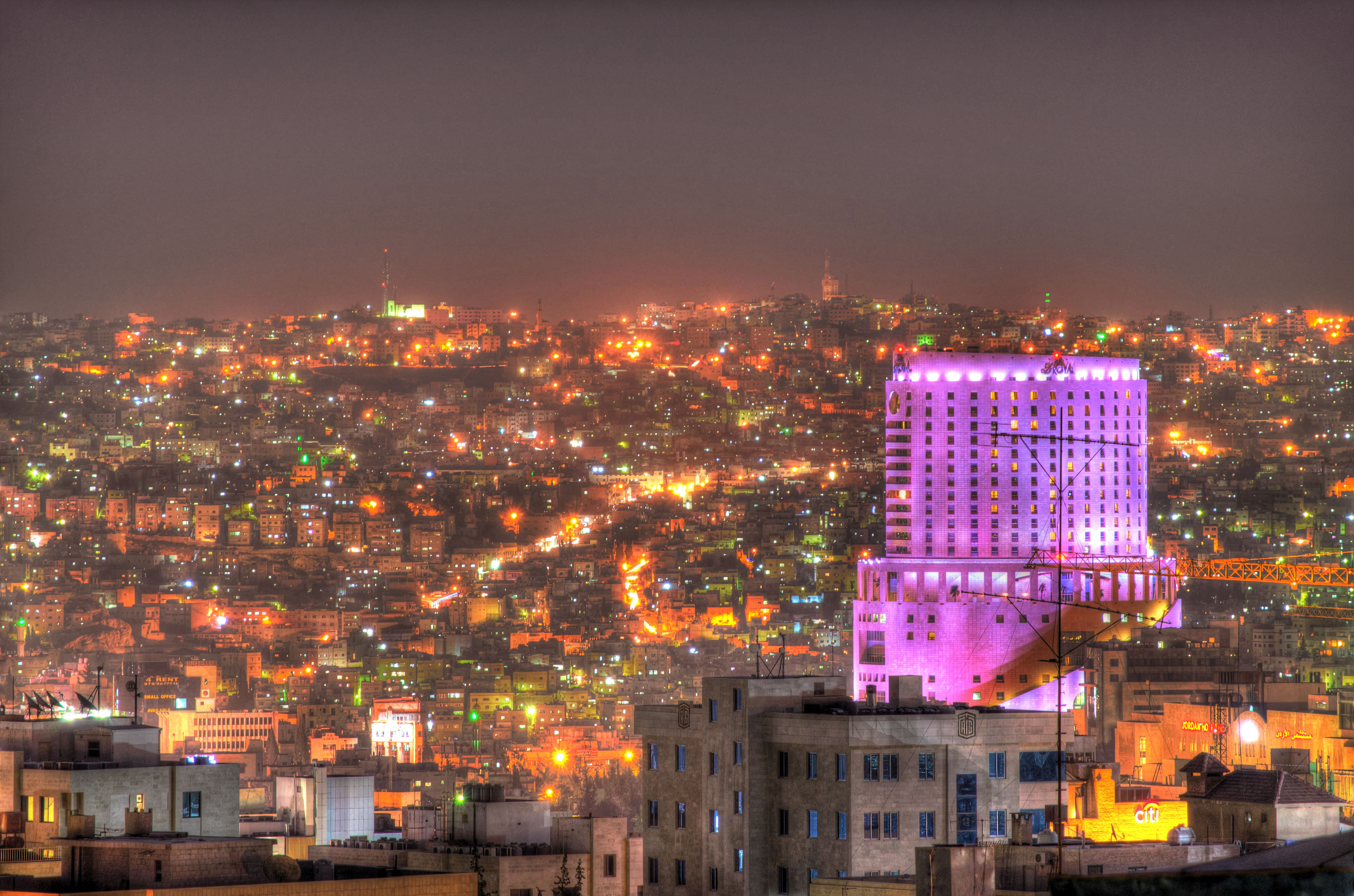 Vibrant nightlife scene on Rainbow Street in Amman, with cafes and people enjoying the evening