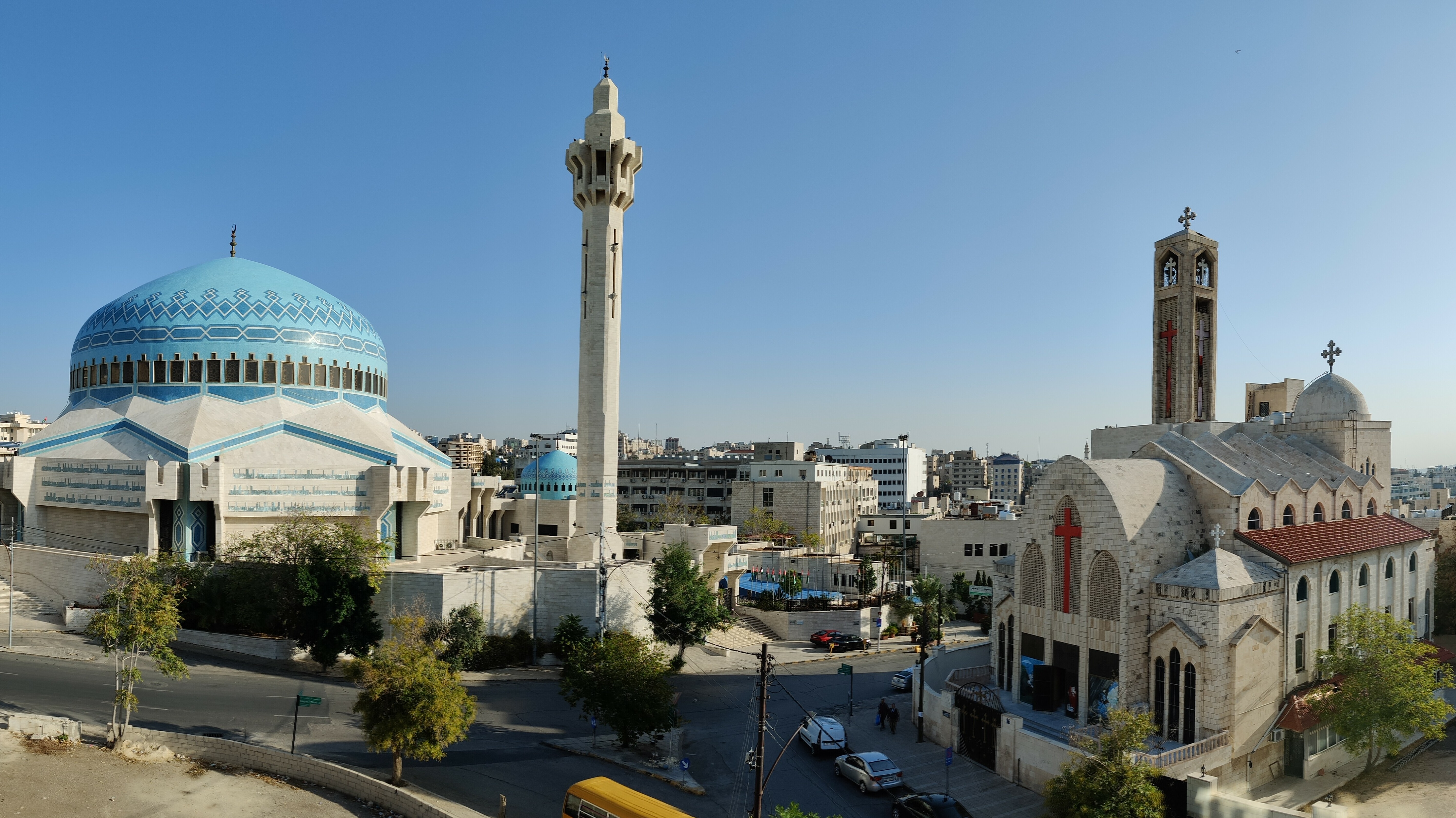 A mosque and a church standing side by side in Amman, symbolizing religious harmony