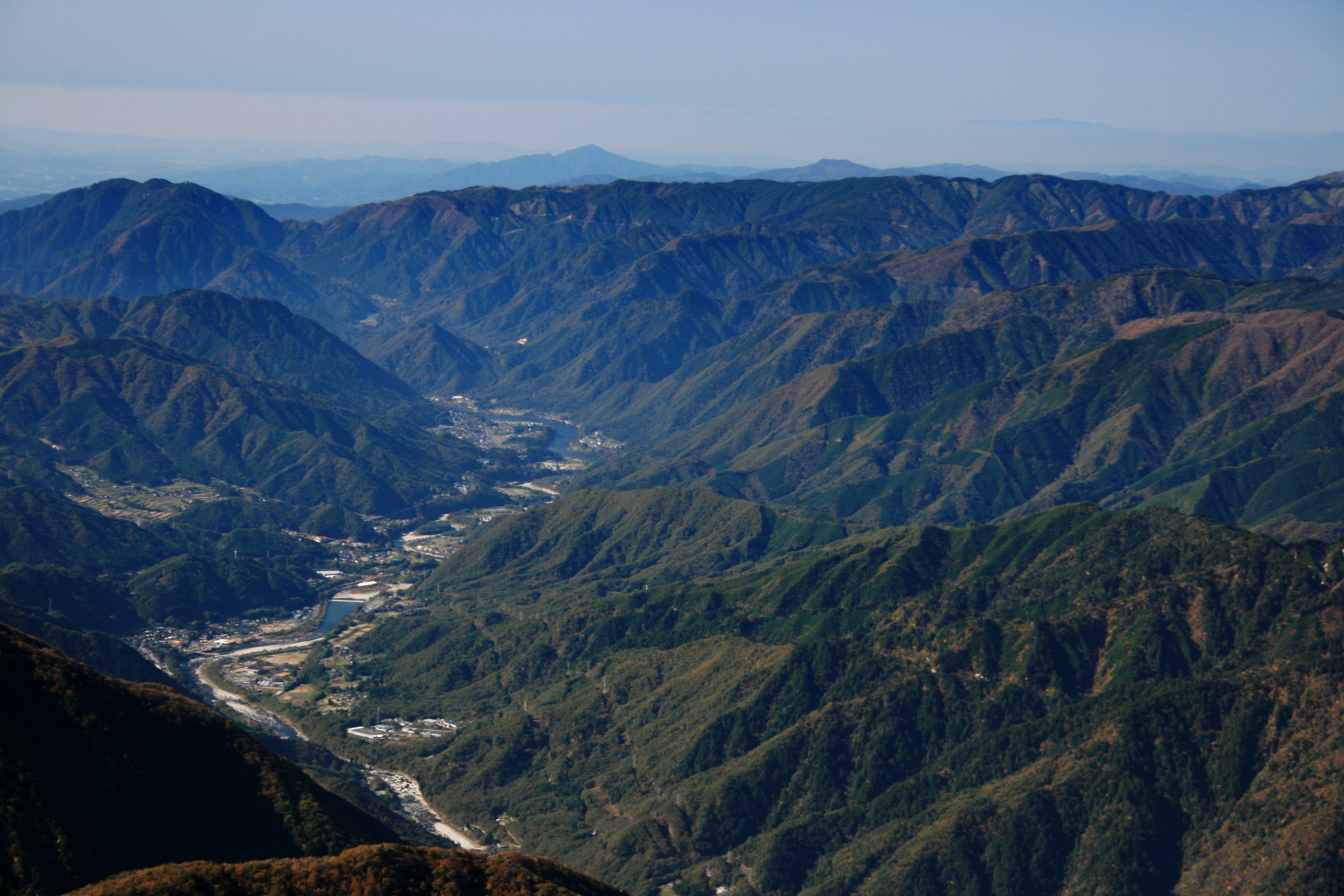 Panoramic view of Kiso Valley from Doppyo, with lush forests, rolling mountains, and scattered traditional villages