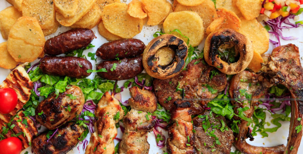 An appetizing spread of traditional Cypriot dishes including souvlaki, halloumi cheese, moussaka, and tzatziki