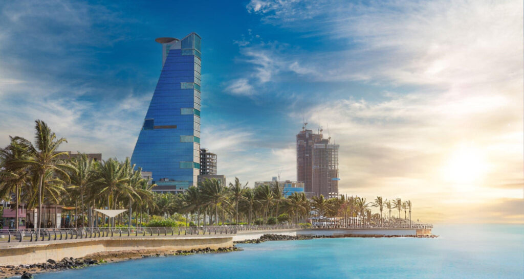 Panoramic view from the sea showcasing Jeddah's skyline and coastline.