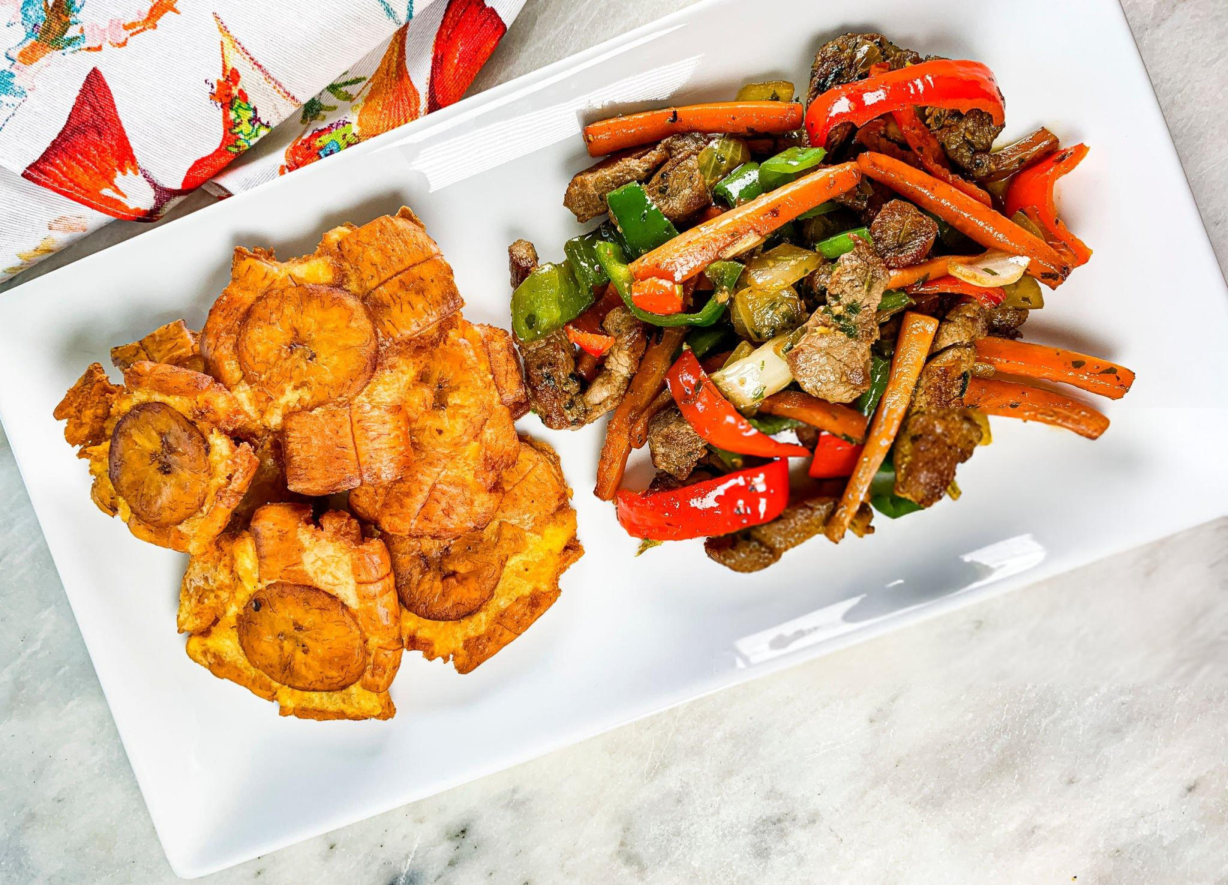 A colorful assortment of Panamanian dishes including ceviche, ropa vieja, and patacones