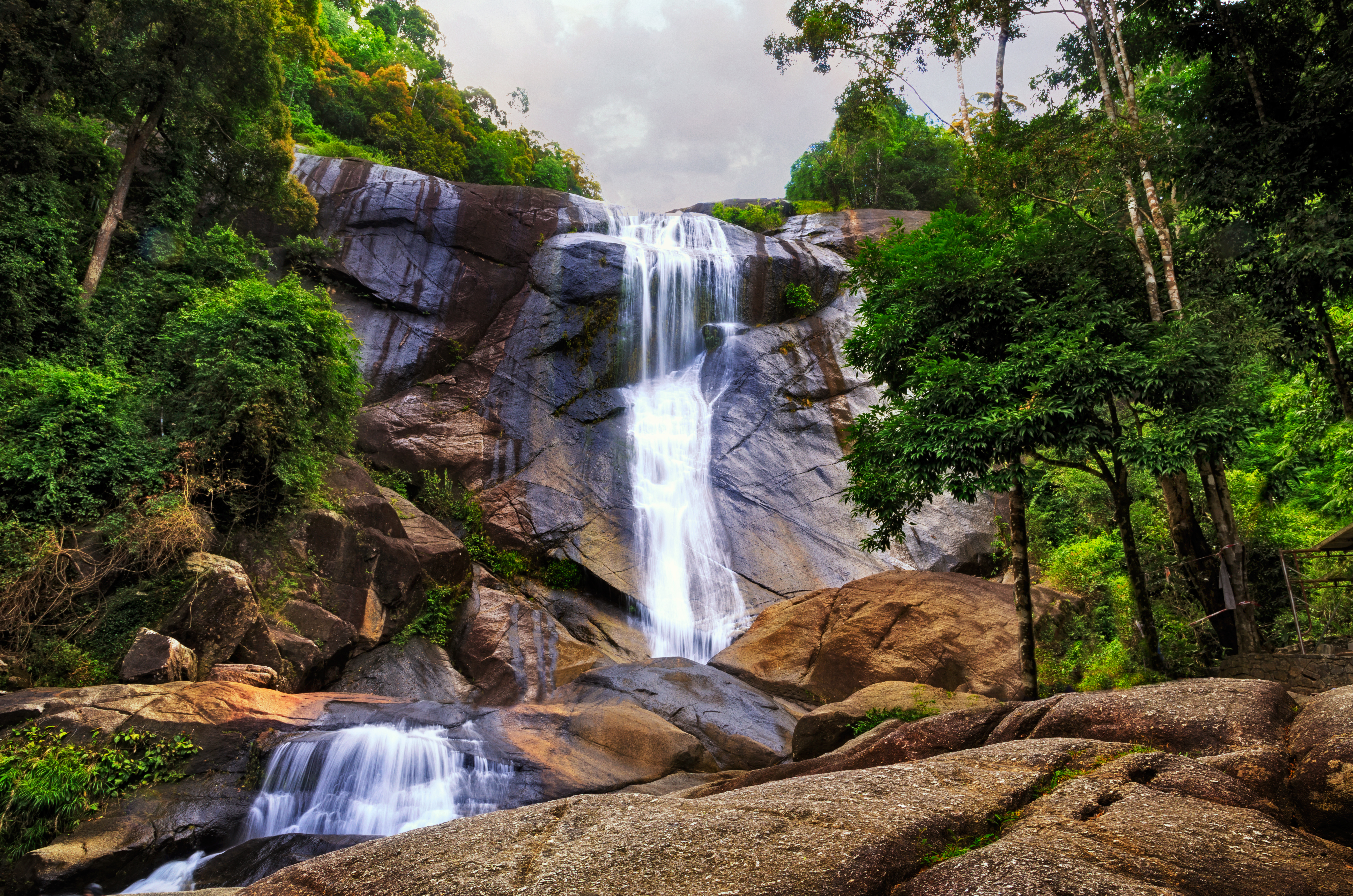 Langkawi waterfalls Serene view of Langkawi waterfalls surrounded by lush greenery