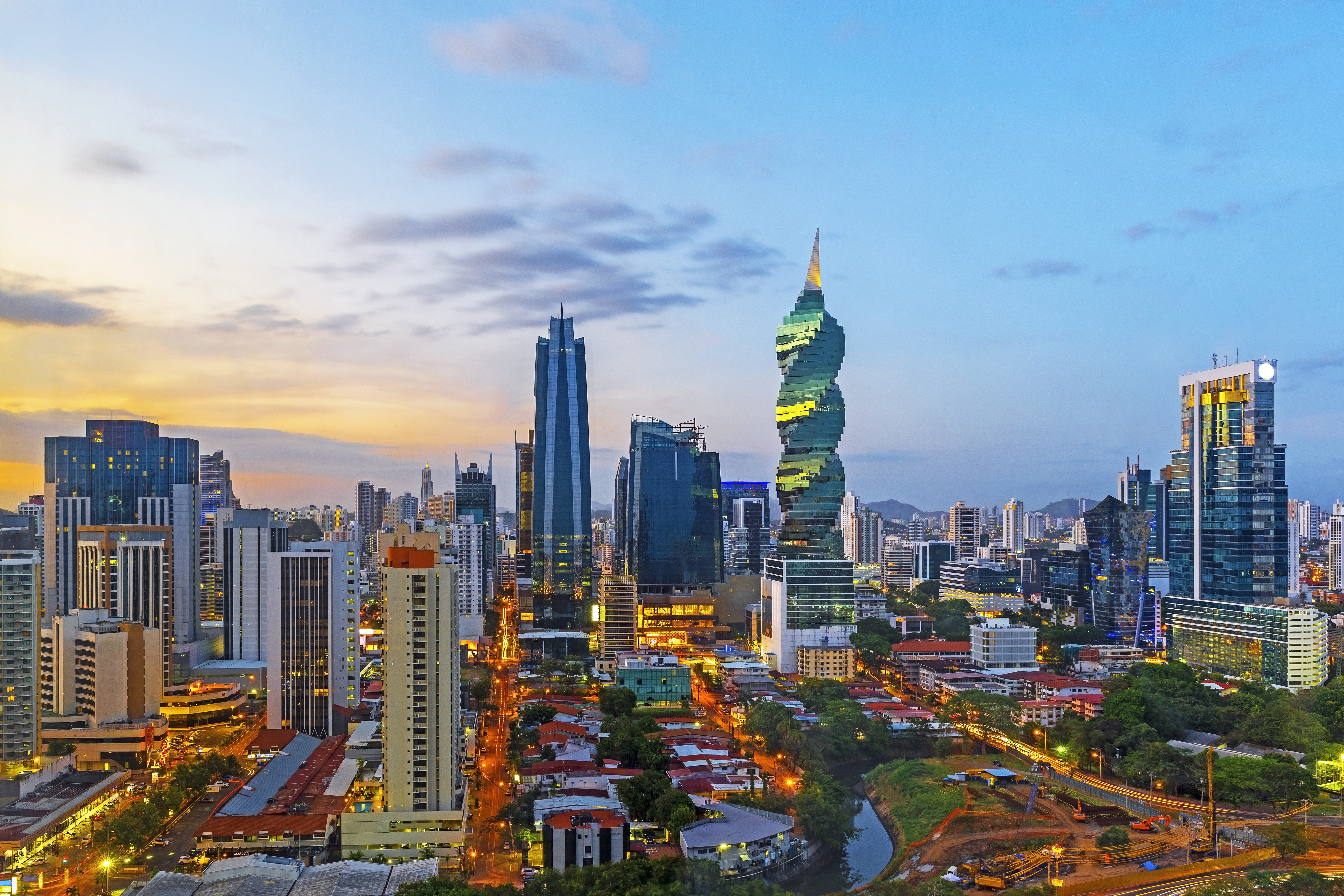 Panama City nightlife with colorful lights illuminating the skyline and bustling streets filled with people enjoying bars and restaurants