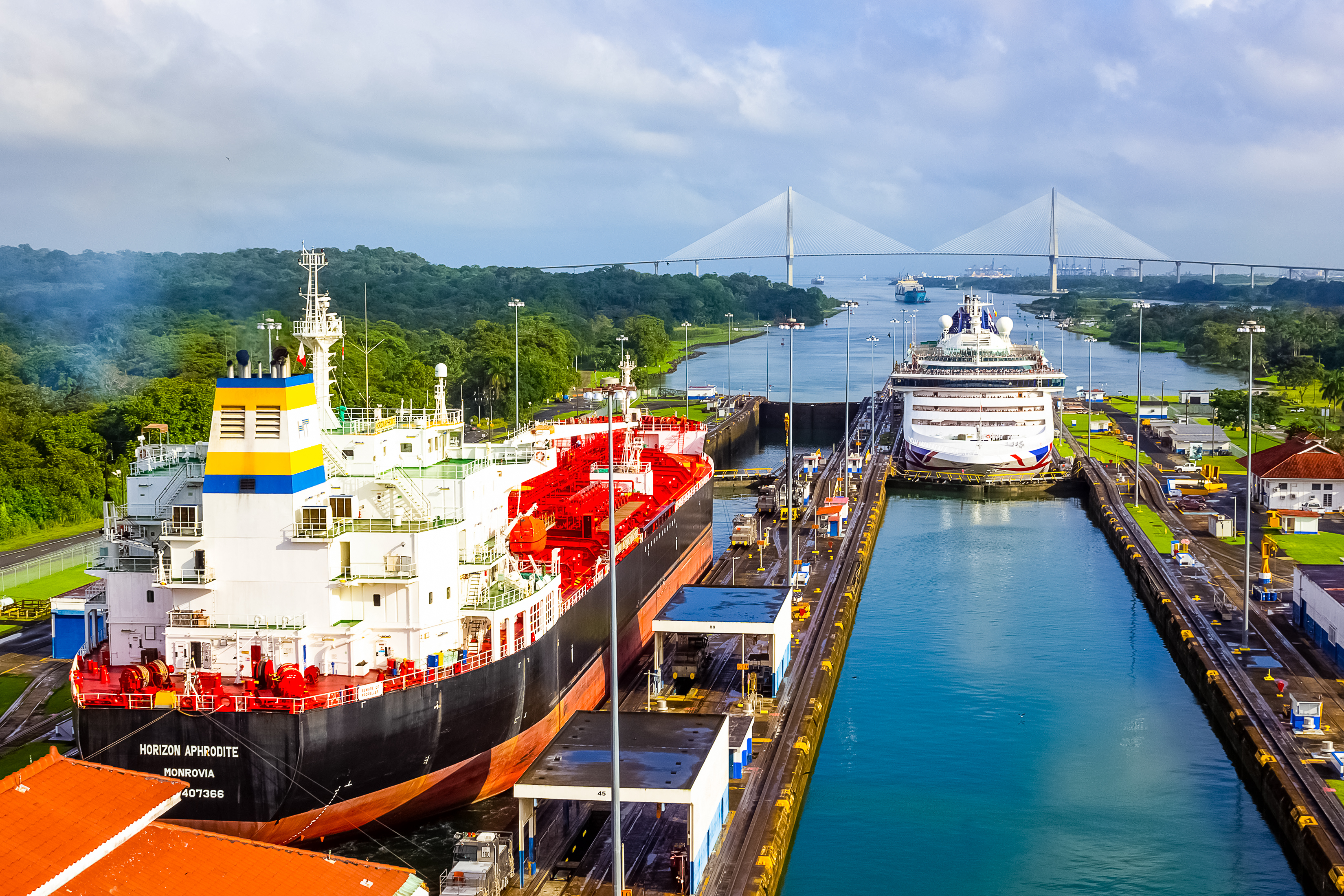 The Panama Canal showing ships navigating through the Miraflores Locks, surrounded by lush greenery and engineering marvels