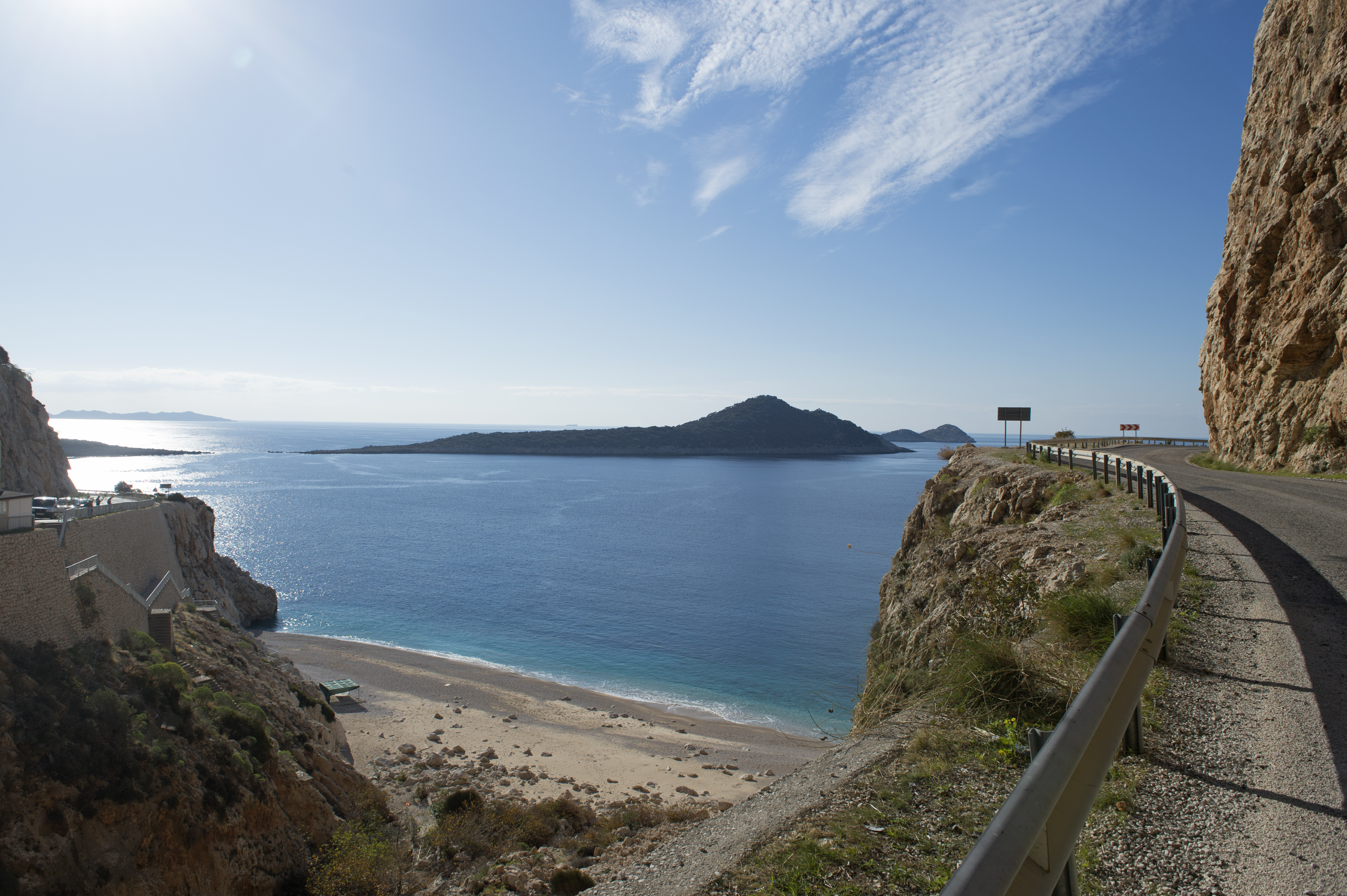 A scenic view of Kaputaş Beach, Turkey, with turquoise waters, sandy beach, and surrounding cliffs