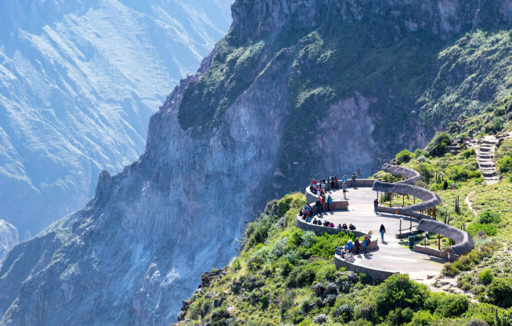 A panoramic view of Colca Valley, Peru, with deep canyons, lush valleys, and mountain ranges