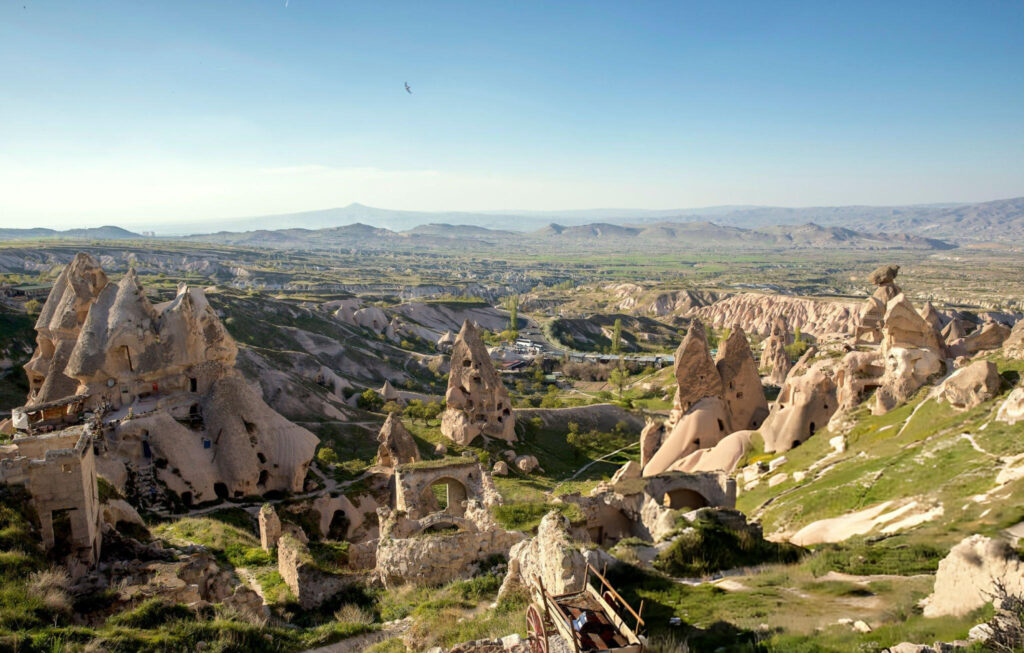 Panoramic view of Ihlara Valley in Cappadocia with lush greenery, steep cliffs, and the Melendiz River winding through the landscape